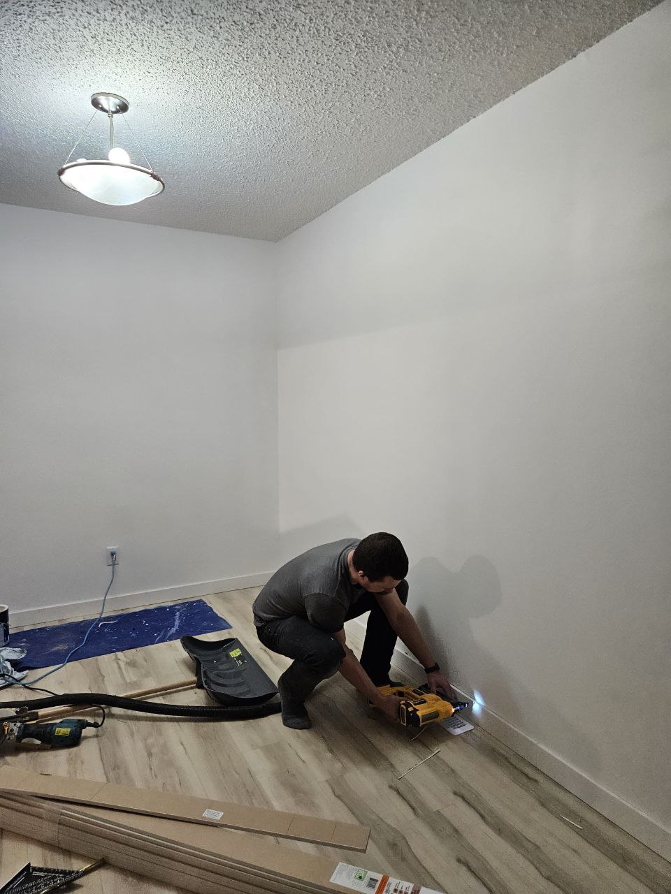 Baseboard installation along freshly painted wall in Calgary